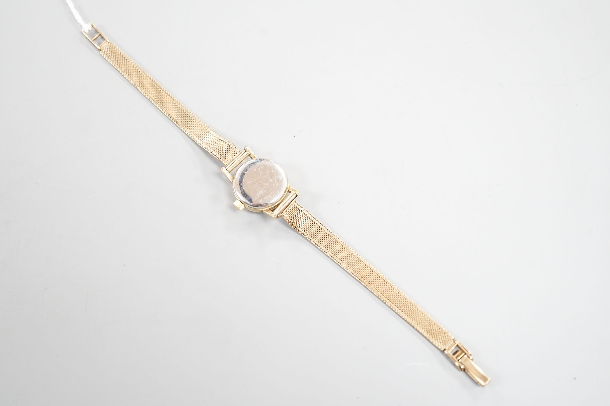 A lady's 1960's steel and gold plated Omega manual wind wrist watch, on an associated 9ct gold bracelet